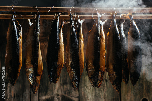 Smoking Process Fish. Fish processing smoking. Mackerel Fish smoked in smokehouse. Smoking Process Fish. banner, menu, recipe place for text photo