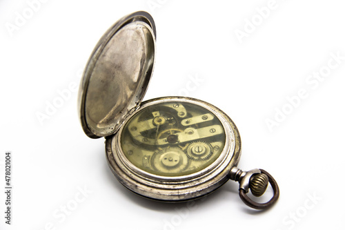 Vintage golden old pocket watch on white background. Old mechanism inside watch