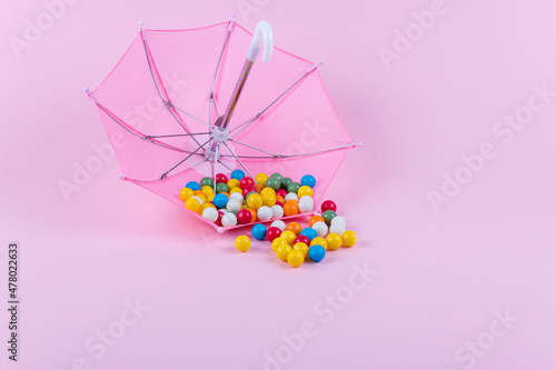 Vászonkép Upturned umbrella with caramel candy