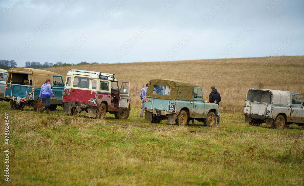 a collection of vintage Land Rover series 2 vehicles off-road driving on Salisbury Plain UK