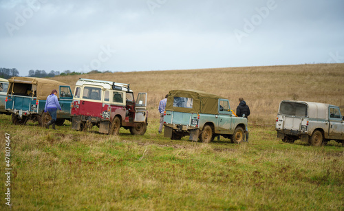 a collection of vintage Land Rover series 2 vehicles off-road driving on Salisbury Plain UK