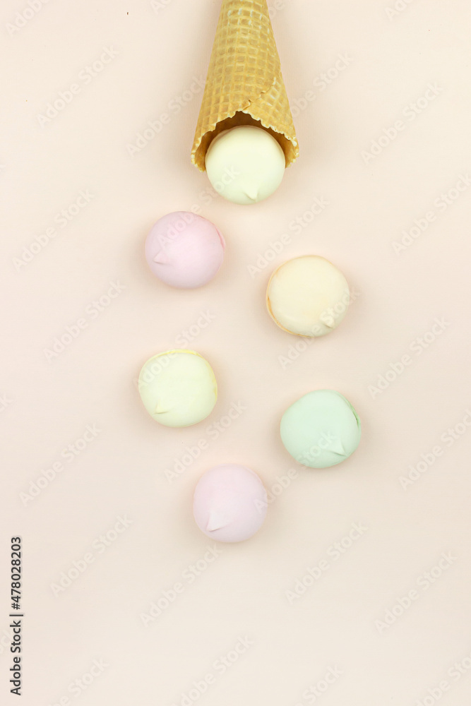 Wafer horn and marshmallow looks like macaroons on a pastel background, top view, flat lay, minimalist trend.Top view, sweets and candy concept. Wafer horn and marshmallow looks like macaroons on a pastel background, top view, flat lay, minimalist trend.Top view, sweets and candy concept.