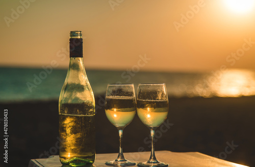 Wine glasses at sunset on the beach. Selective focus.