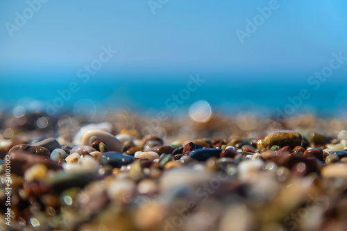 Pebbles on the beach by the sea. Selective focus.