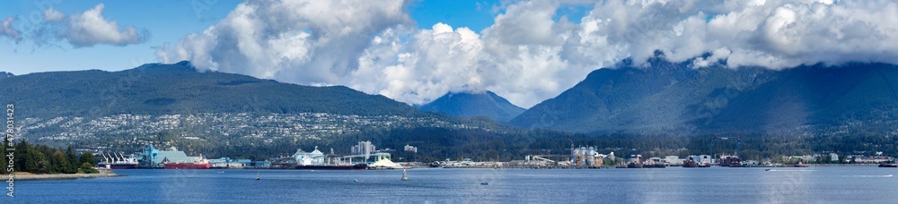Panoramic view of Western Vancouver with seaplanes, barges and a large city, BC, Canada
