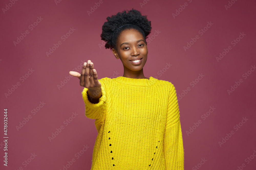 Come here. Toothy smiling young african american girl calling with beckoning gesture, inviting, looking at camera Come here. Toothy smiling young african american girl calling with beckoning gesture, inviting, looking at camera