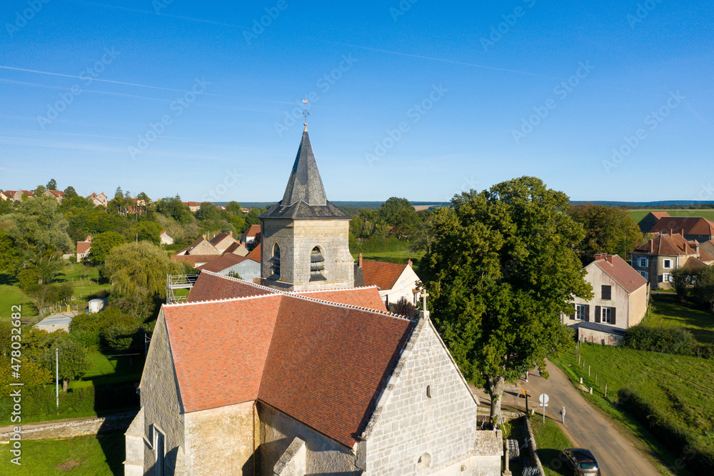 The church and the bronze rooster of Cuncy les Varzy in Europe, France, Burgundy, Nievre, in summer, on a sunny day.