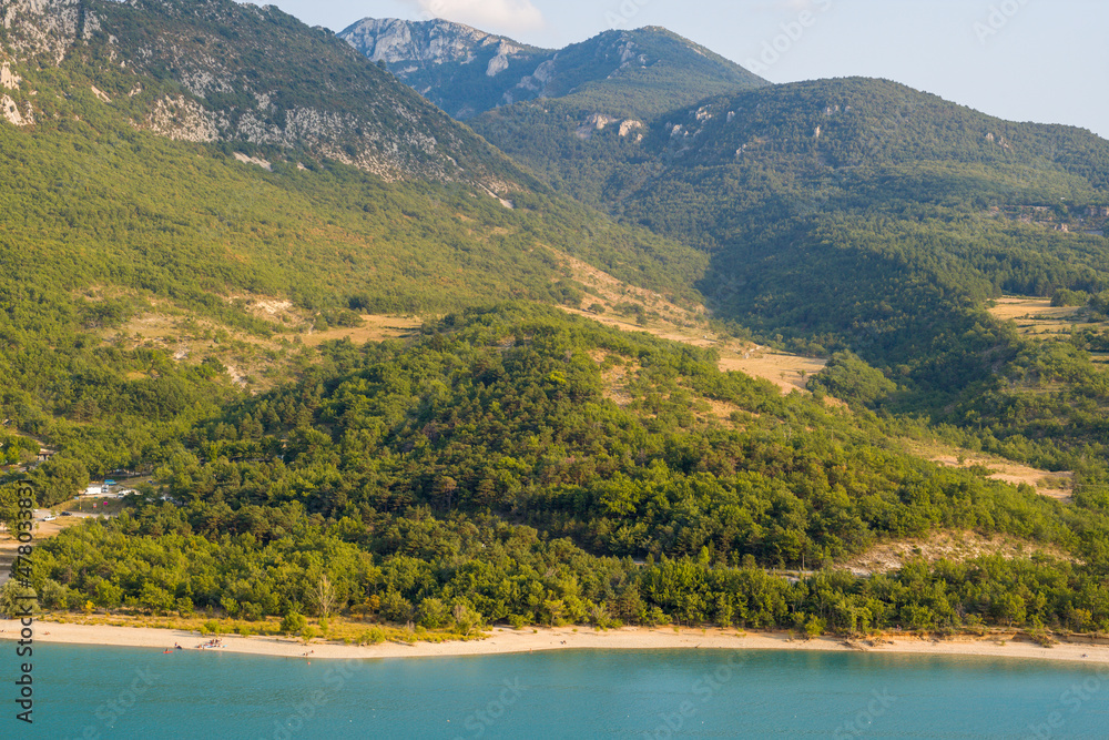 The Lake of Sainte-Croix and its green banks in Europe, in France, Provence Alpes Cote dAzur, in the Var, in summer, on a sunny day.