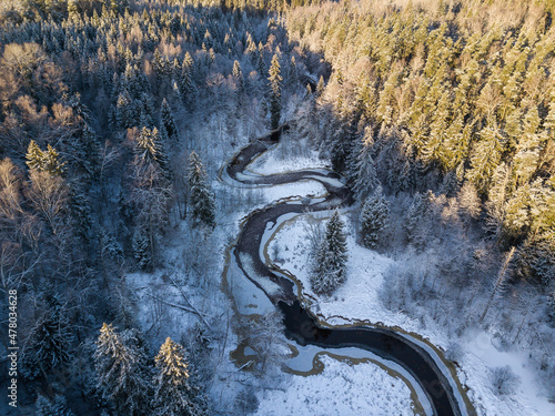 Aerial view of winding river and forest in Riezupe river nature park in winter day, Latvia photo