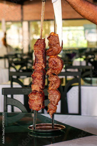 Barbecue steak
in a steakhouse and wood-fired oven
traditional cut of Brazilian beef. Meat served on the plate. photo