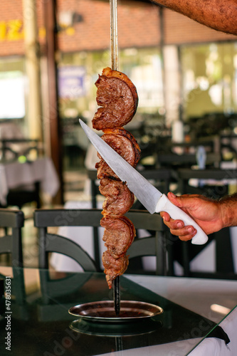 Barbecue steak
in a steakhouse and wood-fired oven
traditional cut of Brazilian beef. Meat served on the plate. photo