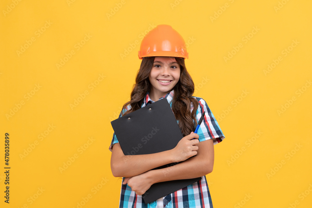 happy teen girl in construction helmet hold in clipboard, verify data happy teen girl in construction helmet hold in clipboard, verify data