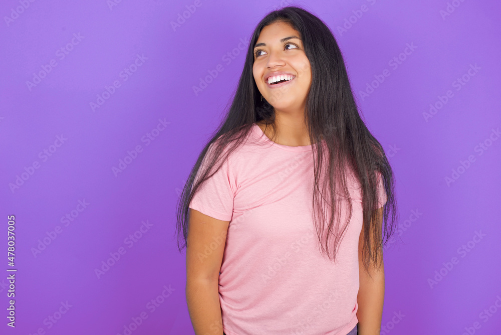 Fototapeta premium Hispanic brunette girl wearing pink t-shirt over purple background very happy and excited about new plans.