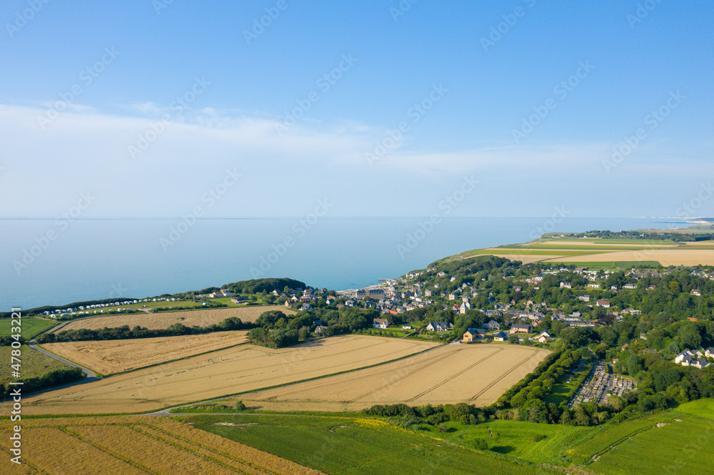 The town of Veules les Roses in the countryside with wheat and flax fields in Europe, France, Normandy, Seine Maritime, in summer on a sunny day.