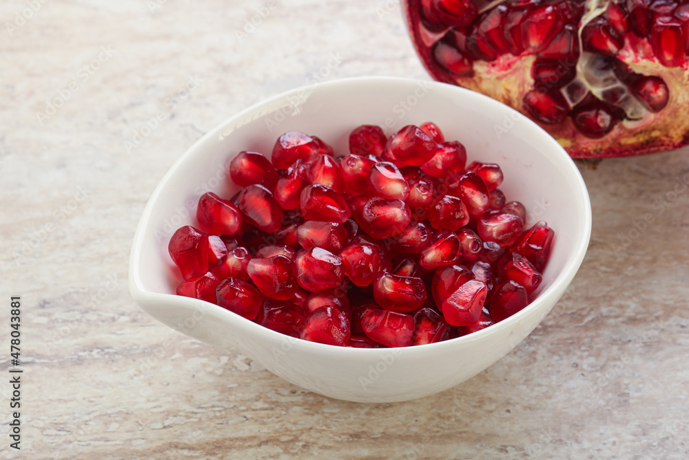 Ripe red Pomegranate seeds in the bowl Ripe red Pomegranate seeds in the bowl