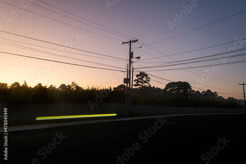 Street lighting pole silhouettes of tree at sunrise in rural area of Guatemala, Central America.