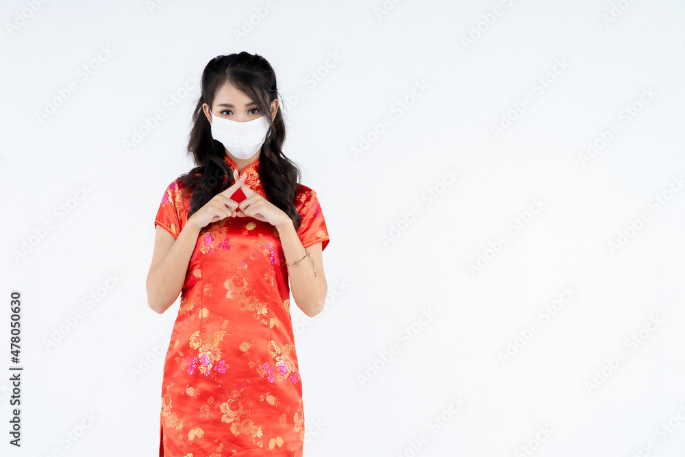 beauty woman wear cheongsam wearing medical mask in chinese new year beauty woman wear cheongsam wearing medical mask in chinese new year
