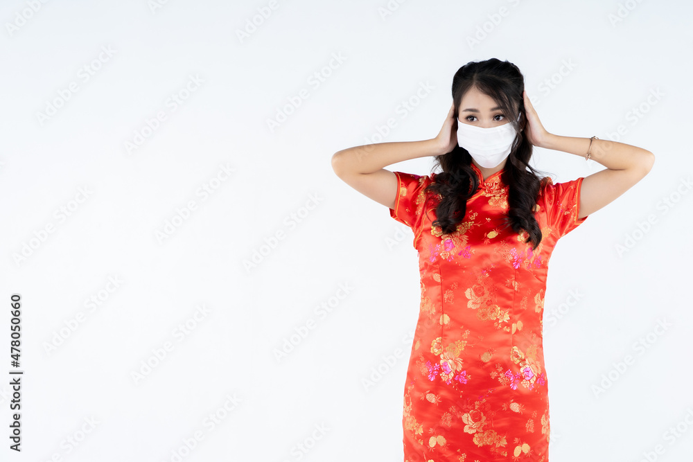 beauty woman wear cheongsam wearing medical mask in chinese new year beauty woman wear cheongsam wearing medical mask in chinese new year