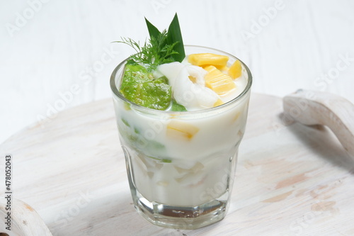 Photography Ice teler or es teler-indonesian fruit cocktail,Avocado, young coconut, jackfruit, served with coconut milk, sweetened condensed milk