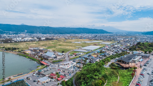 Drone shot of Lake Suwa & Kiso Mountains. Nagano Japan © Overflightstock