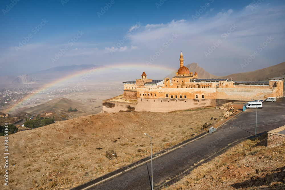 Ishak Pasha Palace with a rainbow at background in Agri city, Eastern Turkey