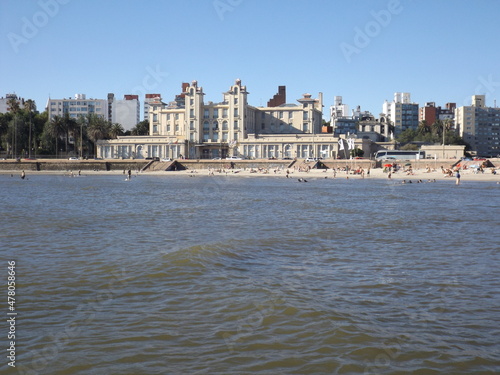 Skyline of the city and Parque Hotel, current Mercosur headquarters from the water.
Old building on the rambla and the coast of Montevideo, Uruguay, in front of Ramirez beach at sunset and blue sky. photo