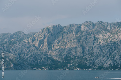 Boats sail on the Bay of Kotor against the backdrop of a mountain range