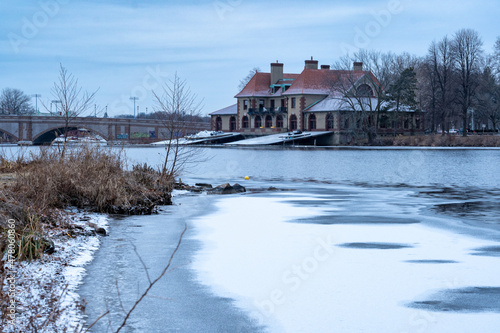 Foto Frozen river in winter and a boathouse