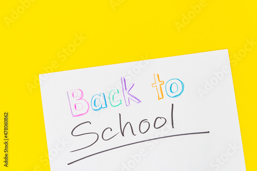 Colorful stationary school supplies with crayon text "Back to School" on yellow trending background with copyspace or text flat lay. Colorful Education or back to school Concept © Thien An Vu