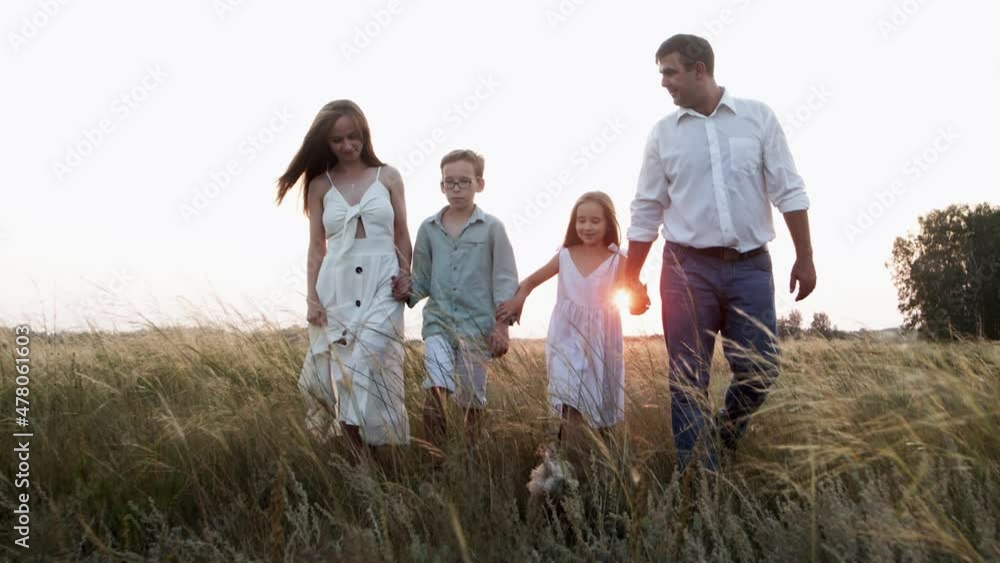Mother, father and children walking together holding hands with cute funny dog. Mother, father and children walking together holding hands with cute funny dog.