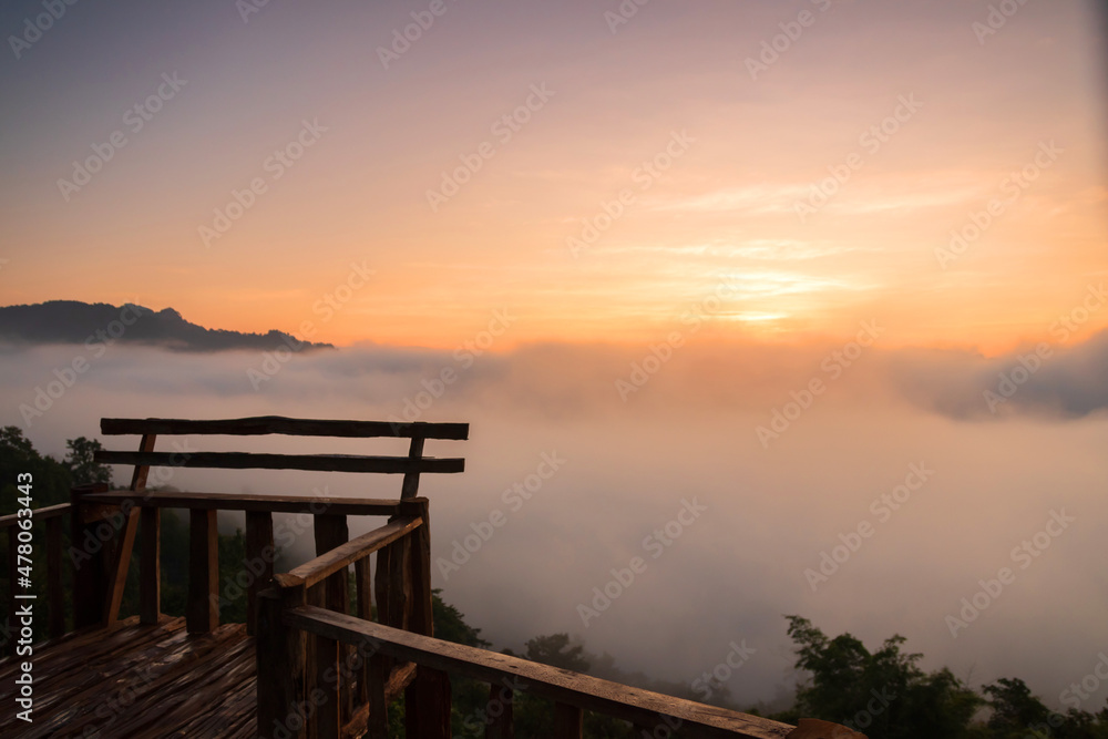 The beautiful early morning sky with twilight and waves of fog at wooden terrace of Baan Ja Bo village viewpoint Pang Mapha, Mae Hong Son, Northern Thailand.