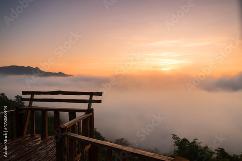 The beautiful early morning sky with twilight and waves of fog at wooden terrace of Baan Ja Bo village viewpoint Pang Mapha, Mae Hong Son, Northern Thailand. © pjjaruwan
