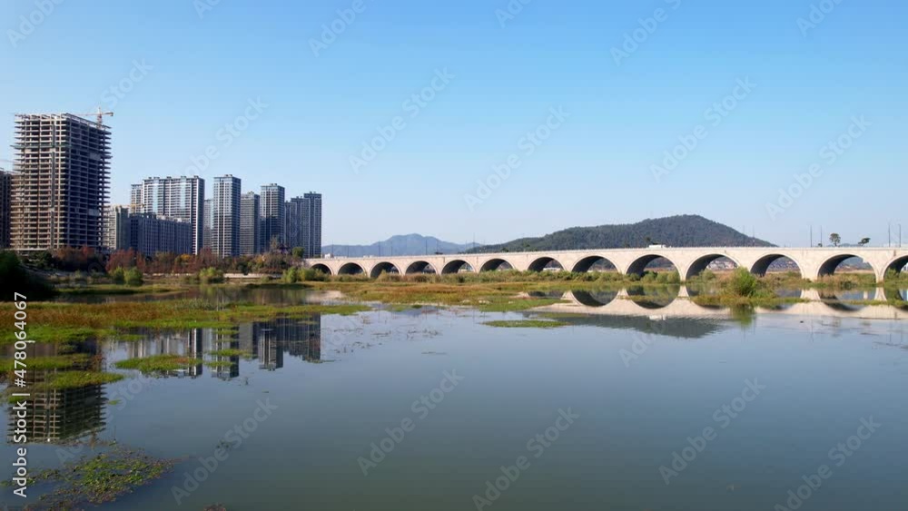 aerial view of arch bridge over tiaoxi river
