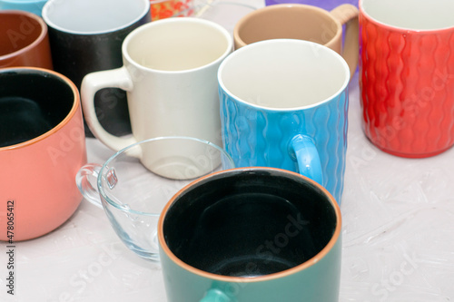 empty mugs of different shapes and sizes on the table