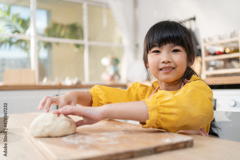 Portrait of Asian young kid girl doing homemade bakery in kitchen. Portrait of Asian young kid girl doing homemade bakery in kitchen.