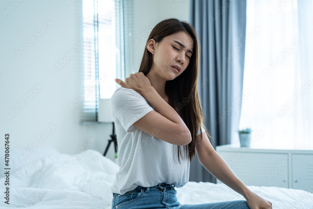 Asian beautiful sick girl in pajamas getting up from sleep in bedroom. Asian beautiful sick girl in pajamas getting up from sleep in bedroom.