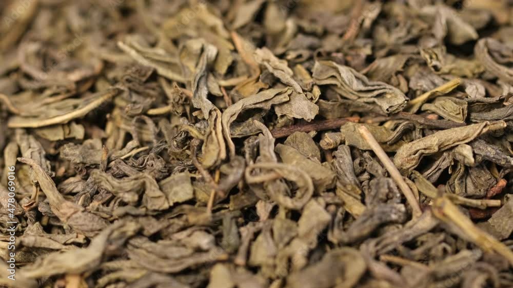 Natural Green Tea, Macro, Dry Healthy Herbs, Isolated, Rotation. Background of Green Tea, Dried Herbs. Healthy food concept Natural Green Tea, Macro, Dry Healthy Herbs, Isolated, Rotation. Background of Green Tea, Dried Herbs. Healthy food concept