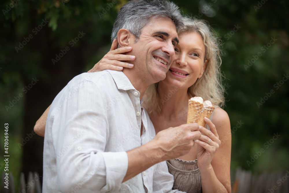 loving senior couple hold ice-creams loving senior couple hold ice-creams