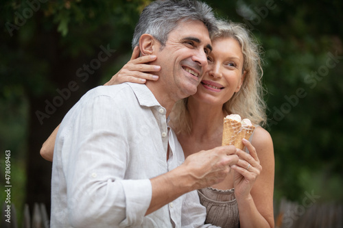 loving senior couple hold ice-creams