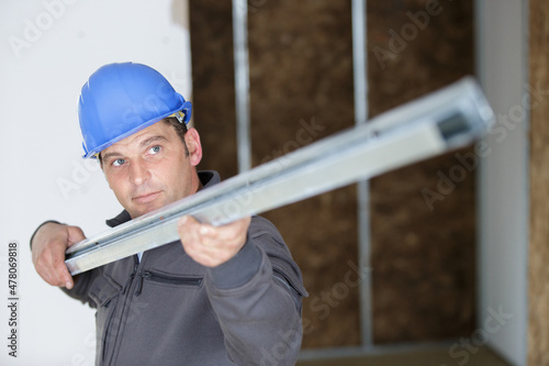 worker checking a metal bar