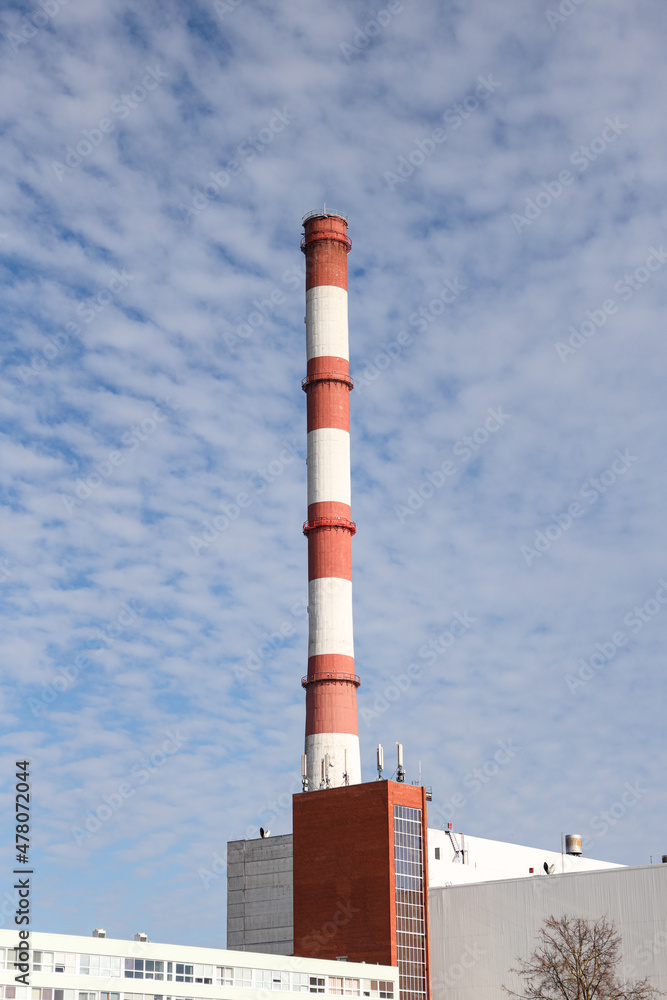 Large, tall electricity thermal power plant red, white color chimney building factory. Large, tall electricity thermal power plant red, white color chimney building factory.