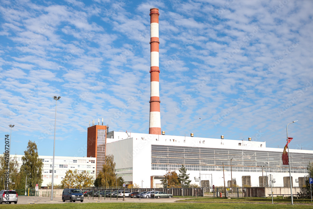 Obraz premium Large, tall electricity thermal power plant red, white color chimney building factory.