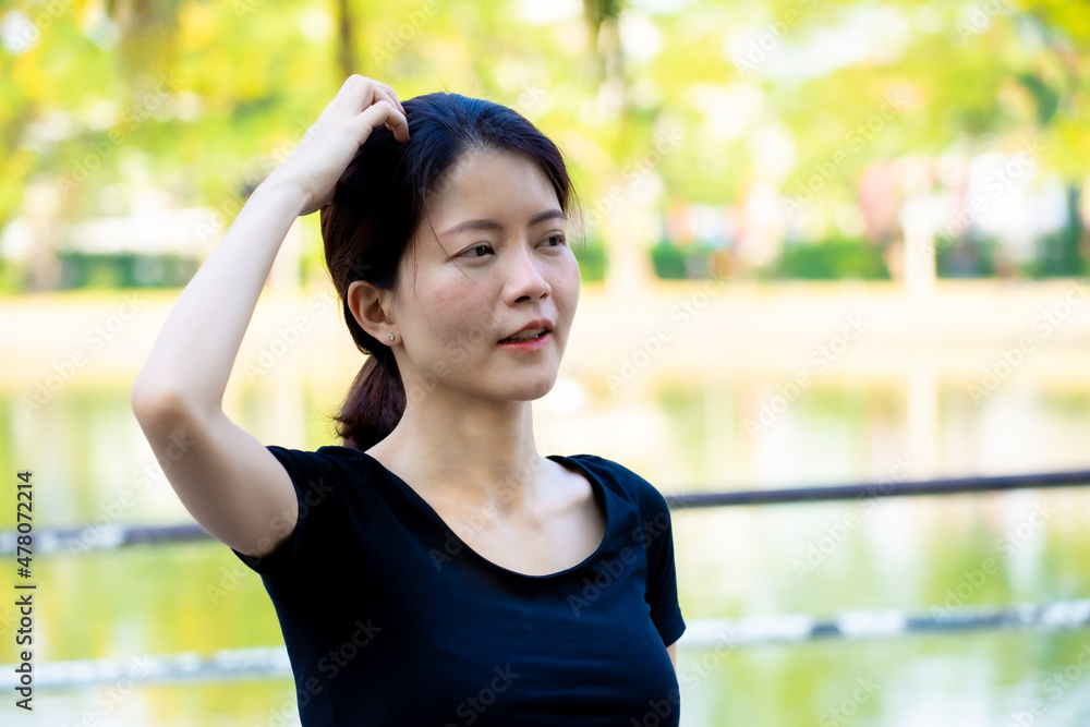Asian woman wearing a black dress portrait in the park Asian woman wearing a black dress portrait in the park
