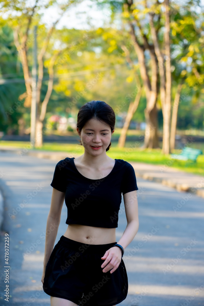 Asian woman wearing a black dress portrait in the park Asian woman wearing a black dress portrait in the park