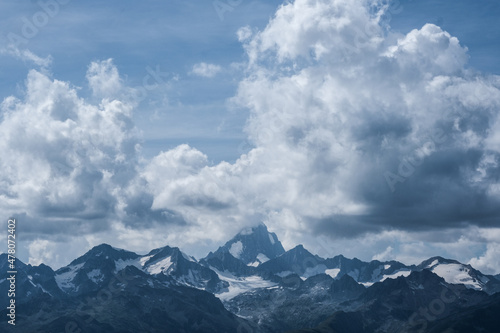 View of a mountain in Switzerland surrounded by clouds.