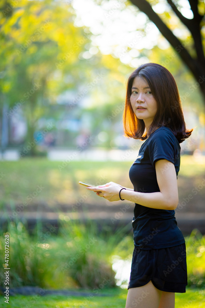 Asian woman wearing a black dress  portrait in the park near river
