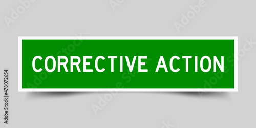 Square label sticker with word corrective action in green color on gray background