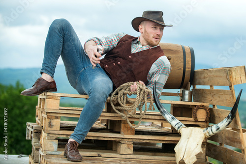 Portrait of farmer or cowboy outdoor. Men retro fashion, vintage vogue, brutal male model.