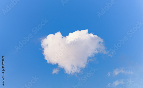 heart shaped cloud on blue sky background.