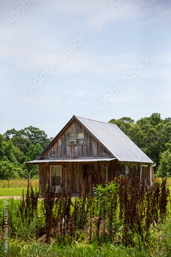 Old dilapidated wooden barn along the side of the road